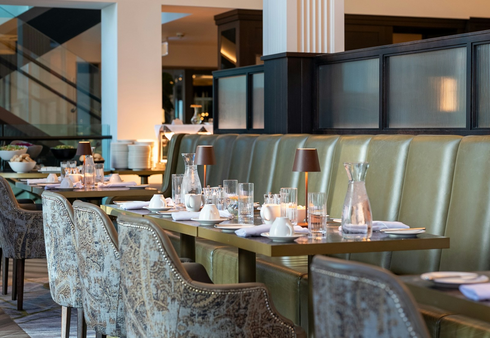 Fine-dining restaurant interior with warm architectural lighting and rich materials