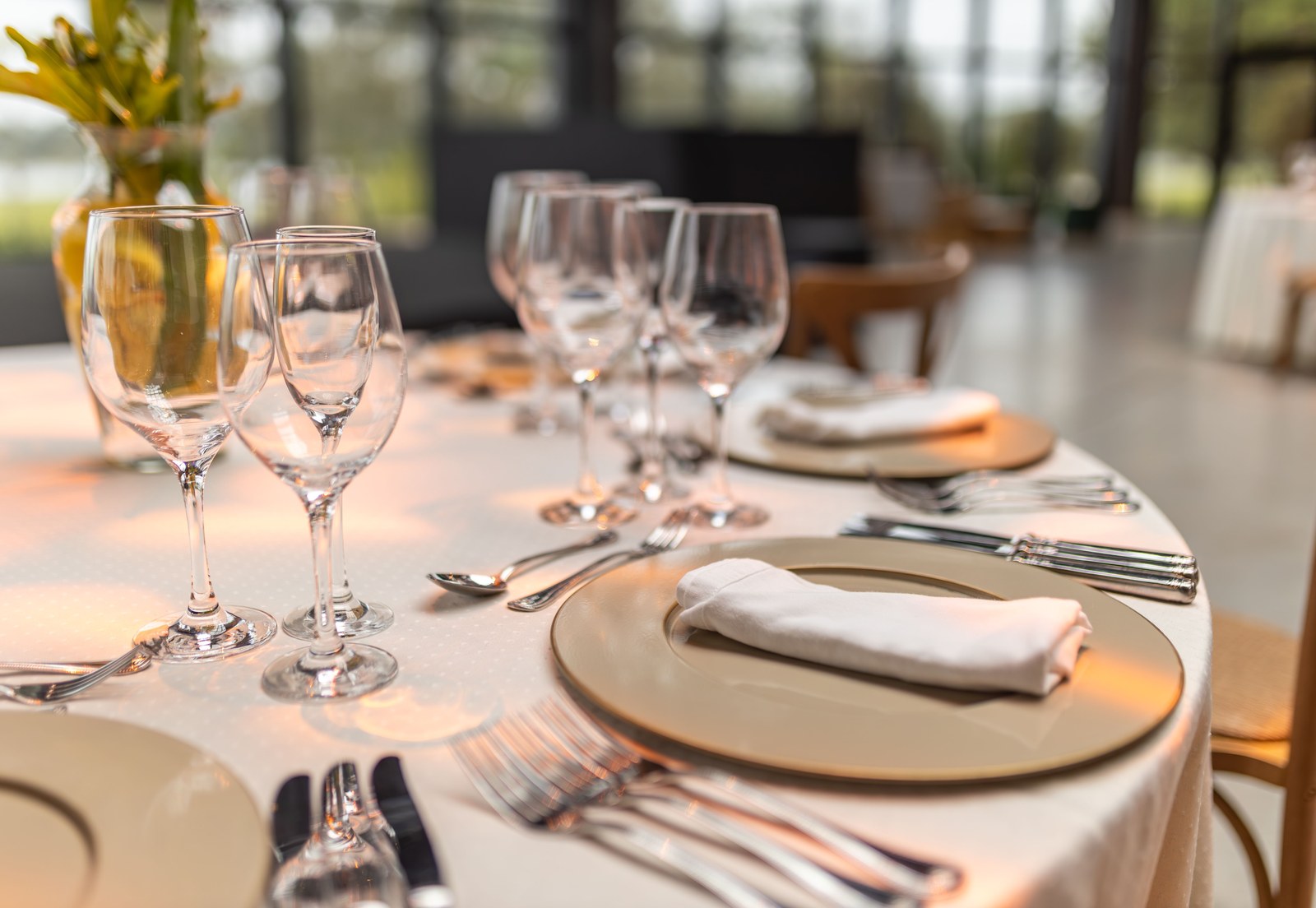 Formal dining table set with crystal glassware and gold charger plates