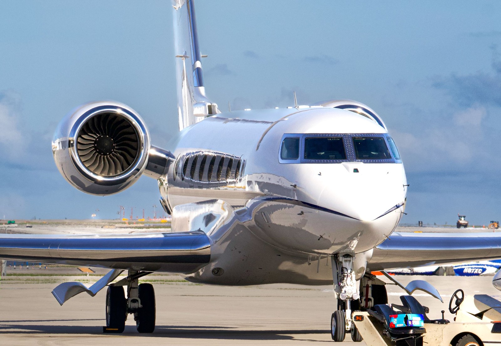 Private jet parked on a quiet airport apron in natural light
