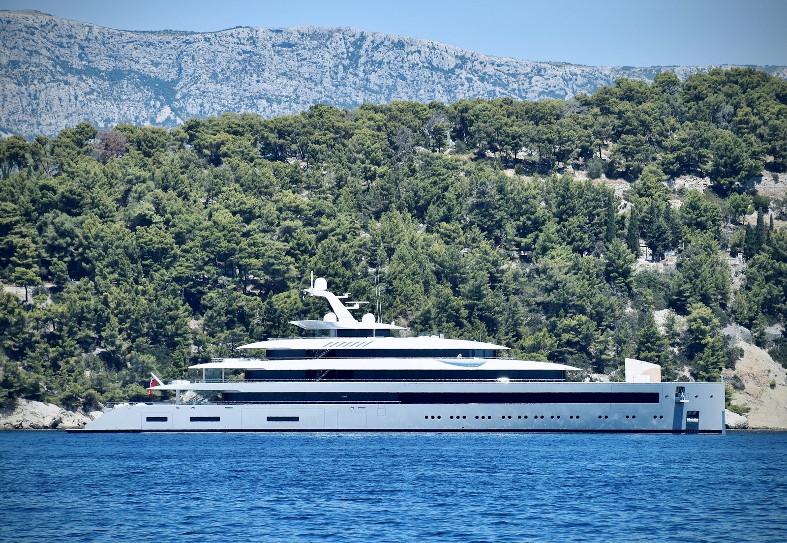 Large multi-deck motor yacht underway on open water